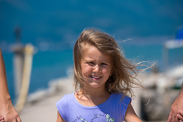 Image showing young happy family walking by the sea