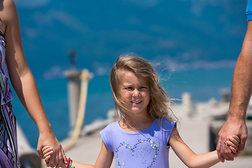 Image showing young happy family walking by the sea