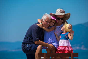 Image showing portrait of grandparents and granddaughters by the sea