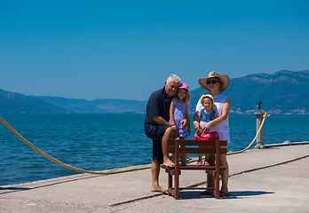 Image showing portrait of grandparents and granddaughters by the sea