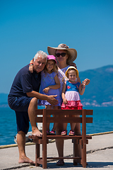 Image showing portrait of grandparents and granddaughters by the sea