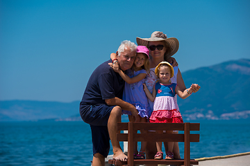 Image showing portrait of grandparents and granddaughters by the sea