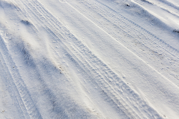 Image showing traces of the wheels of the car on the snow-covered road