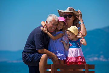 Image showing portrait of grandparents and granddaughters by the sea