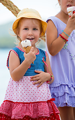 Image showing little girls eating ice cream by the sea