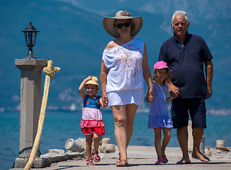 Image showing grandparents and granddaughters walking by the sea