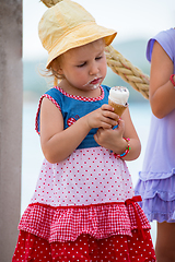 Image showing little girls eating ice cream by the sea