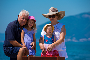 Image showing portrait of grandparents and granddaughters by the sea