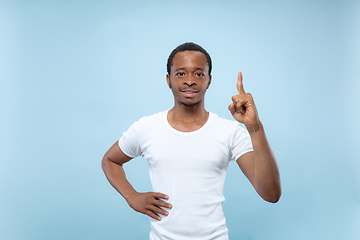 Image showing Half-length close up portrait of young man on blue background.