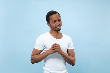 Image showing Half-length close up portrait of young man on blue background.