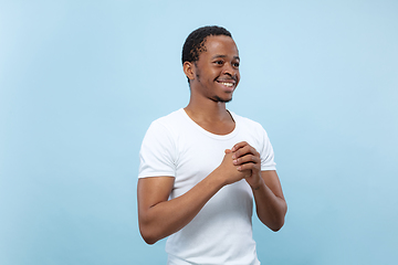 Image showing Half-length close up portrait of young man on blue background.