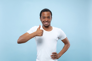 Image showing Half-length close up portrait of young man on blue background.