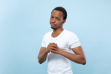 Image showing Half-length close up portrait of young man on blue background.