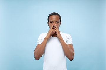 Image showing Half-length close up portrait of young man on blue background.