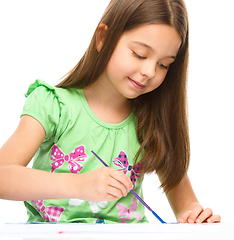 Image showing Little girl is painting with gouache