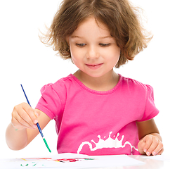 Image showing Little girl is painting with gouache