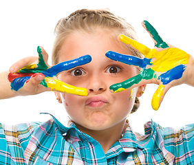 Image showing Portrait of a cute girl playing with paints