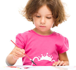 Image showing Little girl is painting with gouache