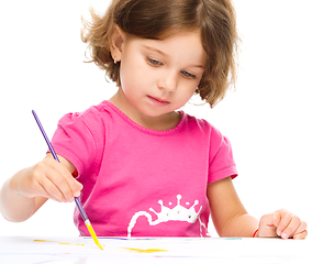 Image showing Little girl is painting with gouache