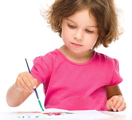 Image showing Little girl is painting with gouache