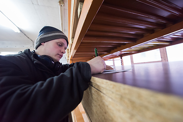 Image showing carpenter writing a receipt