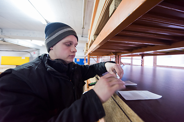 Image showing carpenter writing a receipt