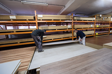 Image showing two young carpenters working in big modern carpentry