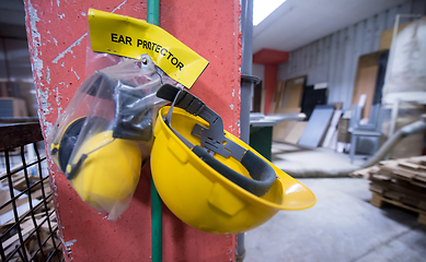 Image showing standard security equipment yellow helmet and ears protection