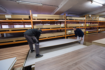 Image showing two young carpenters working in big modern carpentry