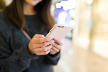 Image showing Woman sending sms on cellphone