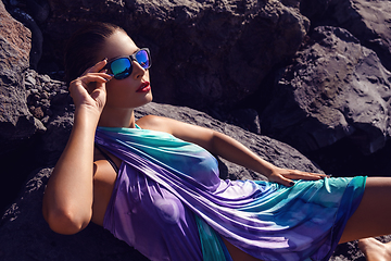 Image showing beautiful girl on rocky shore