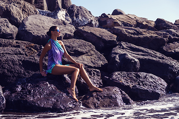 Image showing beautiful girl on rocky shore