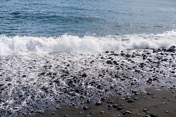 Image showing ocean water on black sand