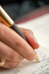 Image showing Hand with pen when signing document.