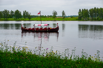 Image showing Old wooden viking boat in river