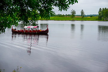 Image showing Old wooden viking boat in river