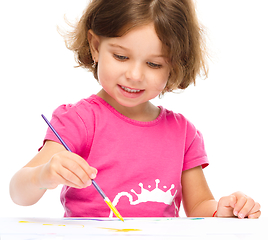 Image showing Little girl is painting with gouache