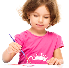 Image showing Little girl is painting with gouache