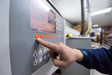 Image showing carpenter calculating and programming a cnc wood working machine