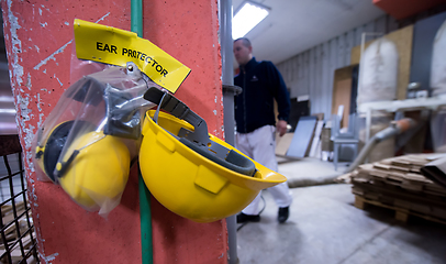 Image showing standard security equipment yellow helmet and ears protection