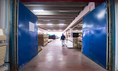 Image showing carpenter walking through factory