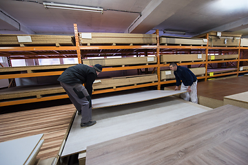 Image showing two young carpenters working in big modern carpentry