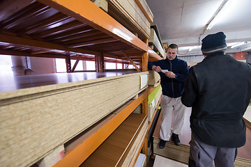 Image showing two young carpenters working in big modern carpentry