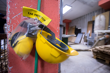 Image showing standard security equipment yellow helmet and ears protection