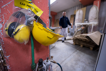 Image showing standard security equipment yellow helmet and ears protection