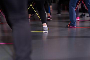 Image showing sporty women exercising with a rubber bands