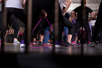 Image showing sporty women exercising with a rubber bands