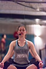 Image showing sportswoman doing yoga exercise and meditating