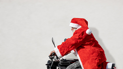 Image showing man on a motorbike in a typical Santa Claus costume