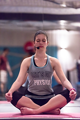 Image showing sportswoman doing yoga exercise and meditating